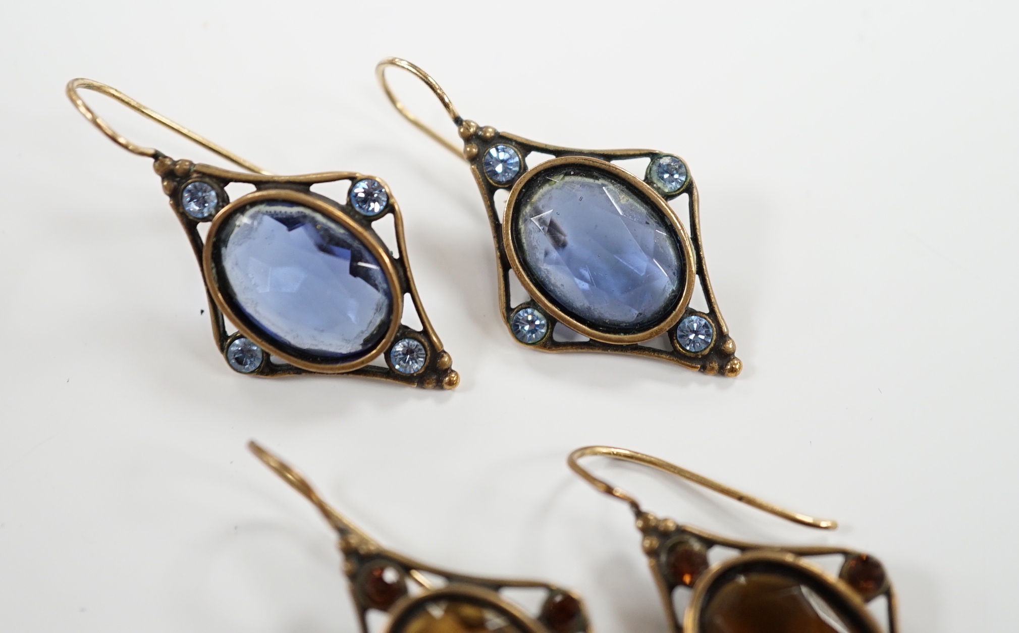 Two pairs of early 20th century gilt metal and coloured paste set drop earrings, overall 37mm.